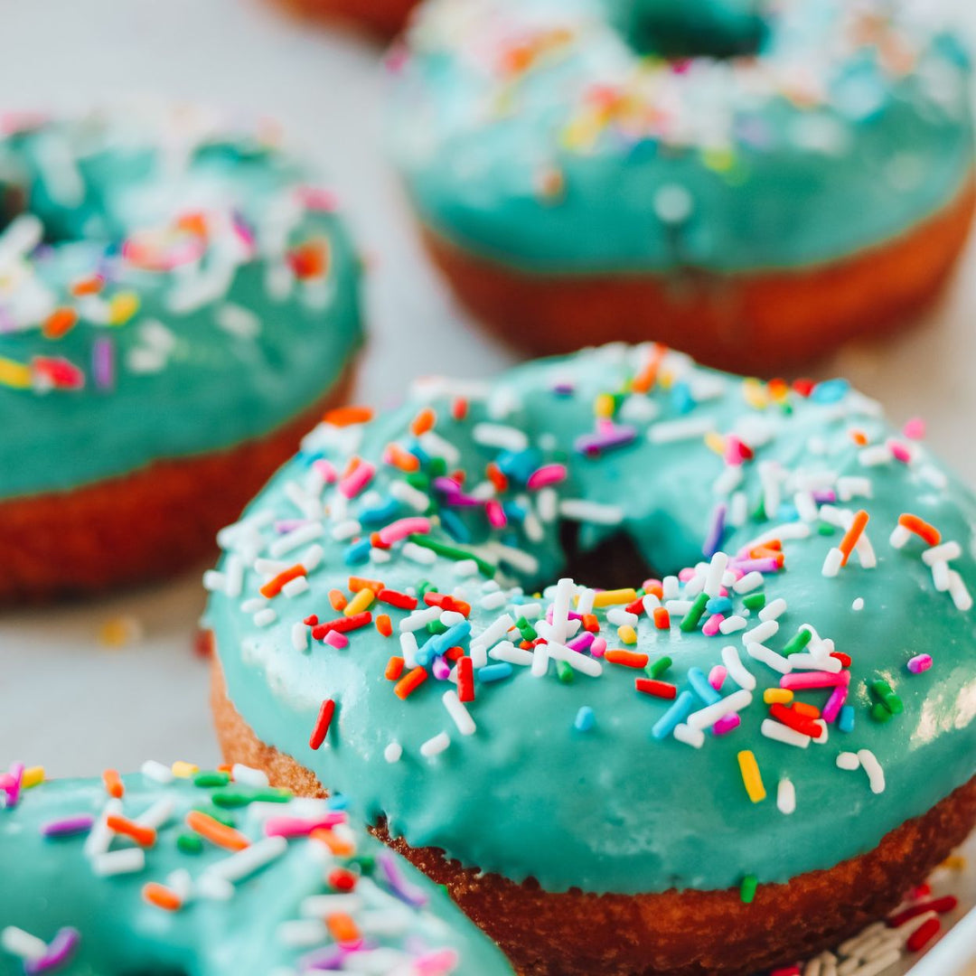 Edmonton-things-to-do-donut-bike-tour-with-food-bike-tour-adventure-edmonton-best-bakeries-Edmonton-food-blog-Edmonton-fun-date-ideas-edmonton-teal-blue-decorated-donuts-3-donuts-on-top-of-each-other-food-bike-tour