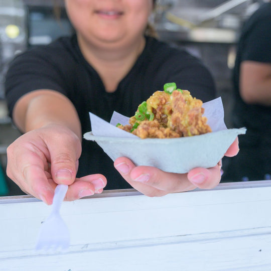 Edmonton-things-to-do-best-restaurants-Edmonton-Alberta-glamping-breweries-Edmonton-biking-tours-best-restraunts-downtown-Edmonton-fun-date-ideas-edmonton-food-bike-tour-women-holding-fork-and-food-from-food-truck-from-tast-e-of-Edmonton-festival