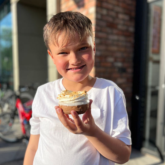 Edmonton-things-to-do-donut-bike-tour-fun-date-ideas-Edmonton-best-doughnuts-in-Edmonton-active-date-ideas-a-little-boy-holding-a-donut-that-he-decorated-food-bike-tour