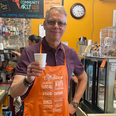 Edmonton-things-to-do-food-bike-tour-alberta-ave-brunch-tour-adventure-Edmonton-cute-date-ideas-Edmonton-older-gentleman-holding-a-cup-of-coffee-at-the-Carrot-coffee-house-brunch-ideas