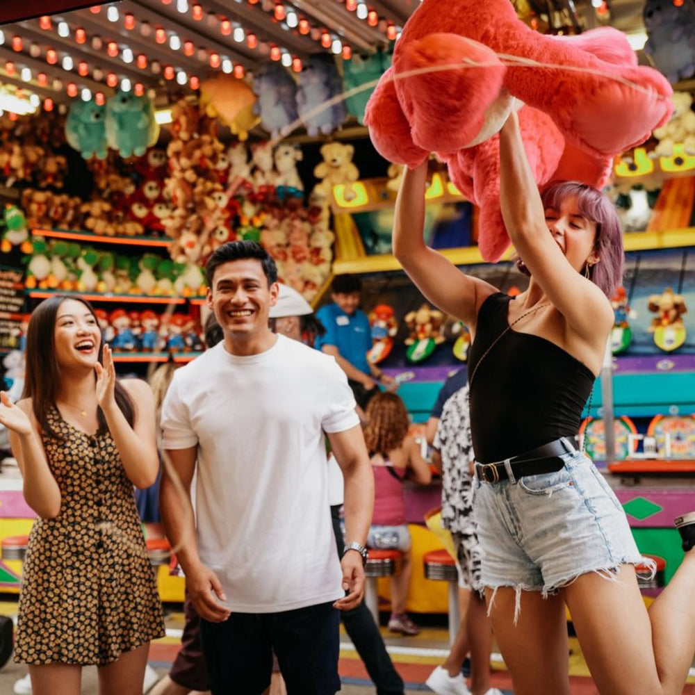 Festivals-in-Edmonton-Festival-food-bike-tour-Edmonton-things-to-do-food-blog-edmonton-Explore-Edmonton-with-K-days-and-Taste-of-Edmonton-friends-playing-a-game-at-kdays-winning-a-stuff-toy-cute-date-ideas-Edmonton-food-blog-Edmonton