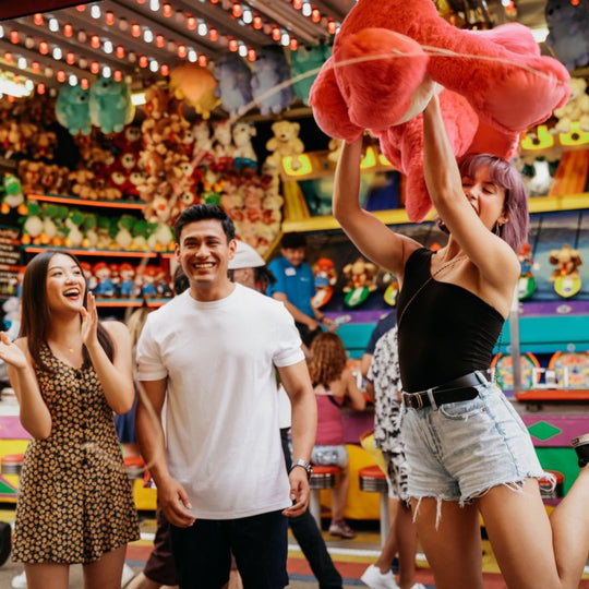 Festivals-in-Edmonton-Festival-food-bike-tour-Edmonton-things-to-do-food-blog-edmonton-Explore-Edmonton-with-K-days-and-Taste-of-Edmonton-friends-playing-a-game-at-kdays-winning-a-stuff-toy-cute-date-ideas-Edmonton-food-blog-Edmonton