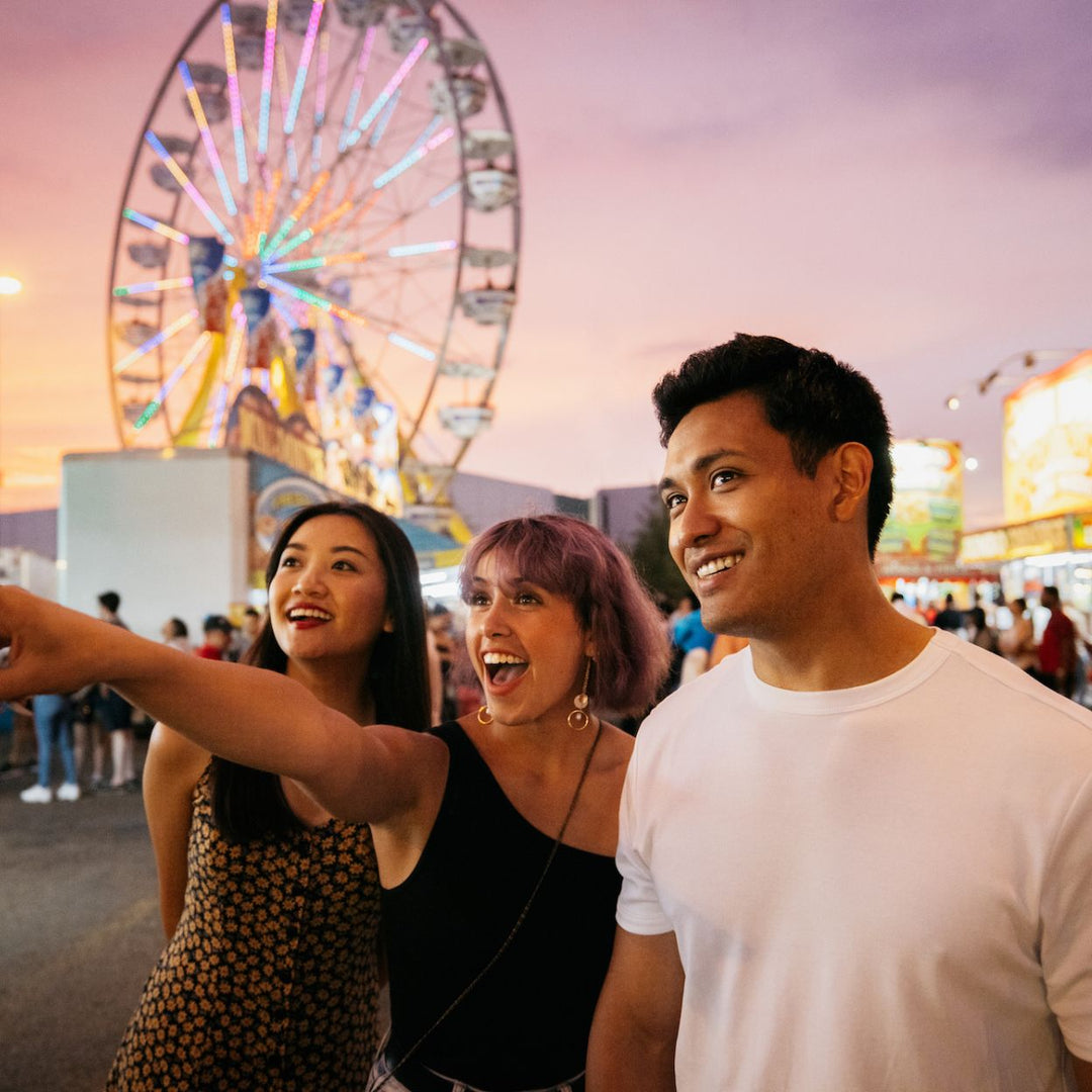 VIP-k-Days-Food-Walk-Tour-Edmonton-festivals-best-restaurant-edmonton-Edmonton-things-to-do-2-girls-and-a-boy-at-k-days-pointing-and-smiling